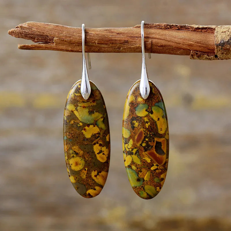 Verdant Stone elongated drop earrings in gold with natural stone pattern.