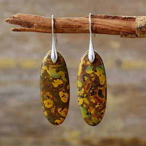 Verdant Stone elongated drop earrings in gold with natural stone pattern.