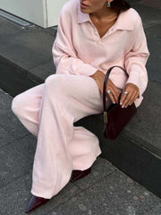 Pink knit polo sweater and wide-leg pants set with button detail and ribbed cuffs.