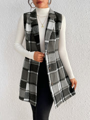 Black plaid sleeveless blazer dress with button front, styled over a white turtleneck.