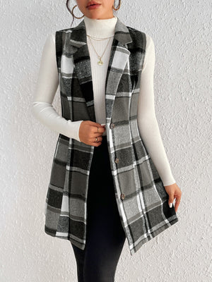Black plaid sleeveless blazer dress with button front, styled over a white turtleneck.