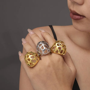Openwork orb rings in gold and silver with a contemporary, casual style.