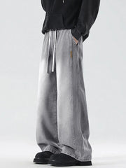 Oversized drawstring washed denim jeans in cement gray with a relaxed fit.