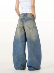 Vintage washed oversized men's jeans in blue denim with a relaxed fit and faded details.