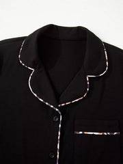Black pajama set with leopard trim detail on collar, pocket, and buttons.