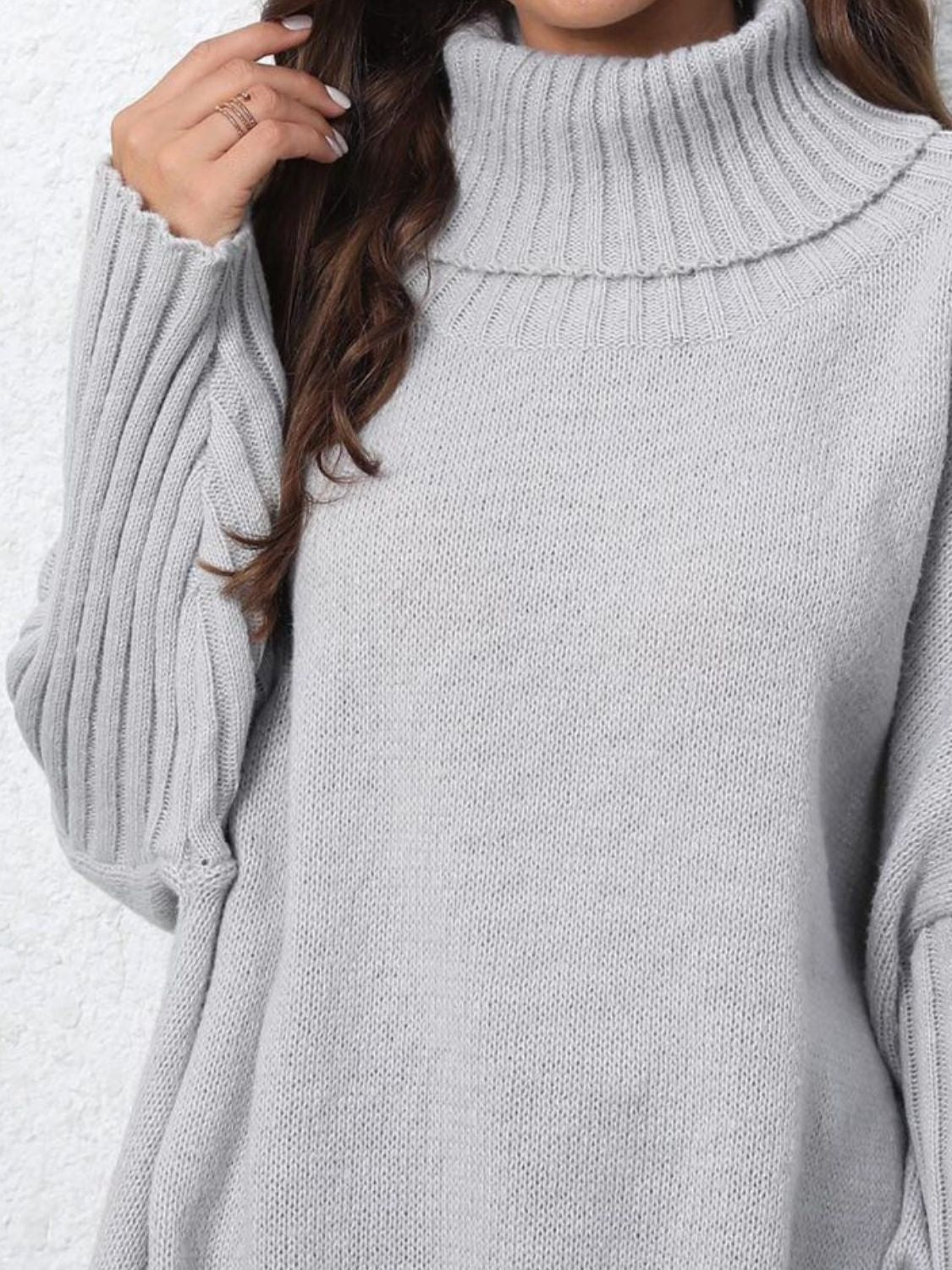 Light gray turtleneck slouchy knit sweater with ribbed cuffs and neckline.
