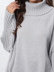 Light gray turtleneck slouchy knit sweater with ribbed cuffs and neckline.