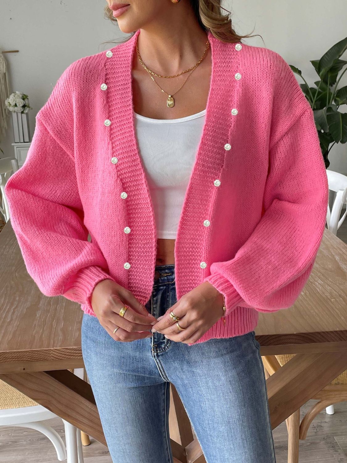 Fuchsia pink bubble sleeve cardigan with pearl buttons and a relaxed fit.