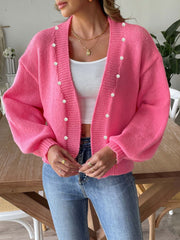 Fuchsia pink bubble sleeve cardigan with pearl buttons and a relaxed fit.