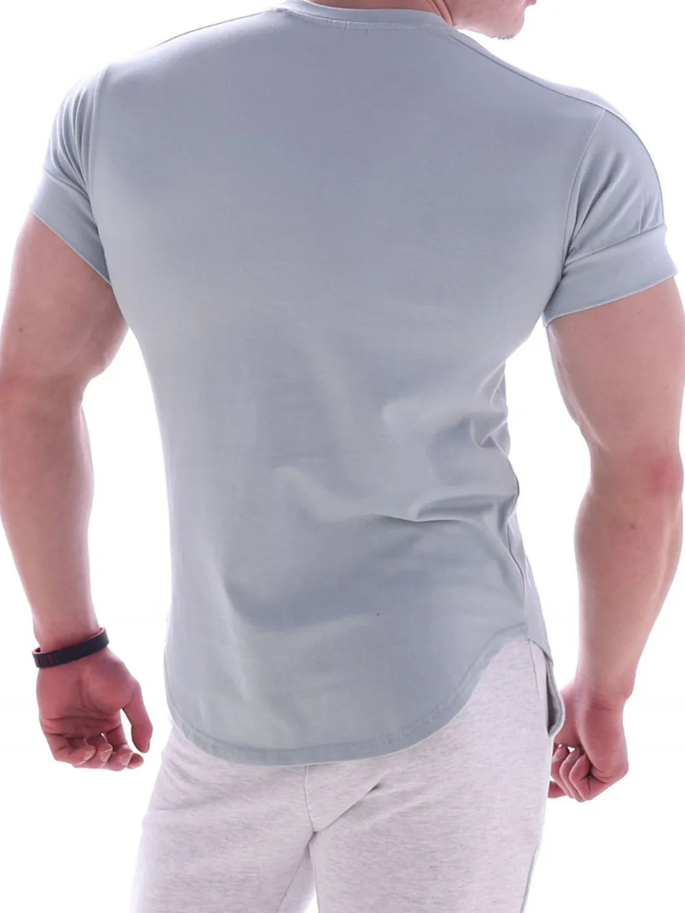 Light blue performance tee with curved hemline and rolled sleeves.