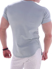 Light blue performance tee with curved hemline and rolled sleeves.