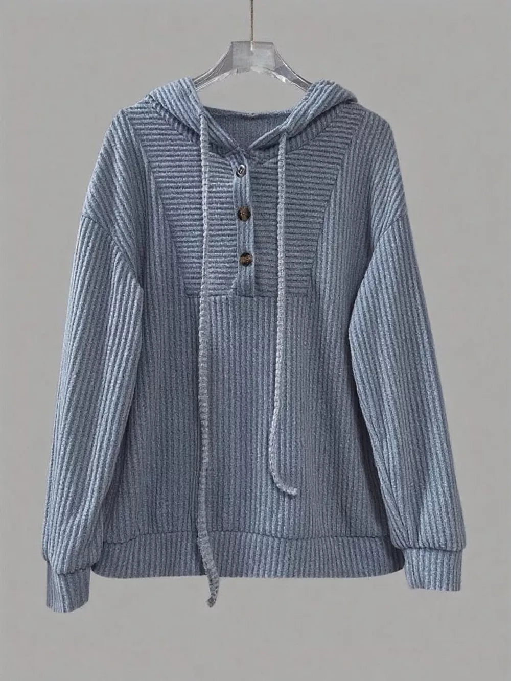 Dusty blue ribbed button-front hoodie with drawstring and two buttons at neckline.