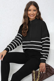 Black ribbed knit quarter-zip sweater with white stripes on sleeves and body.