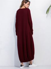 Burgundy balloon hem maxi dress with long sleeves and round neckline.