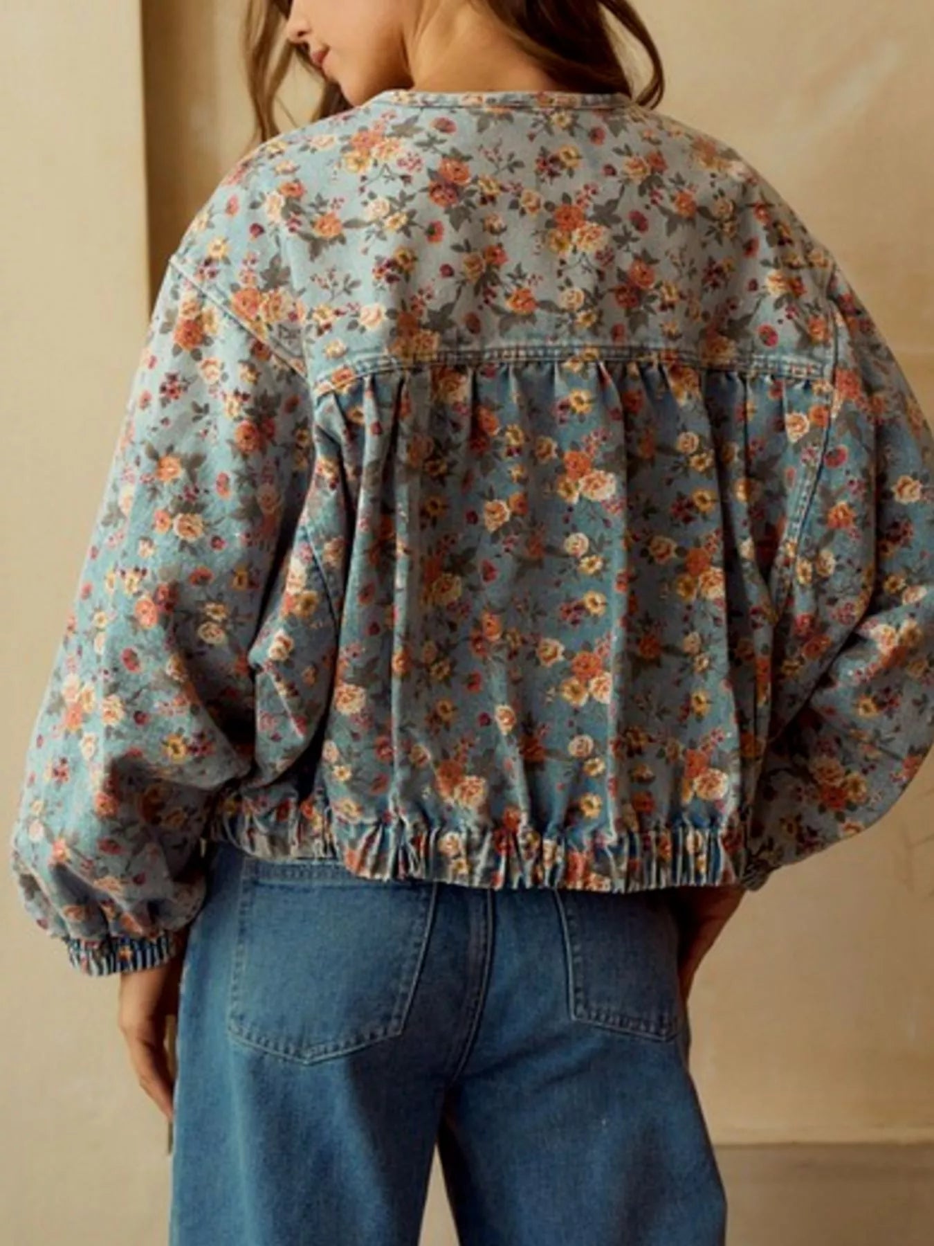 Cropped denim trucker jacket with floral print, elasticated hem and cuffs, and gathered back detail.