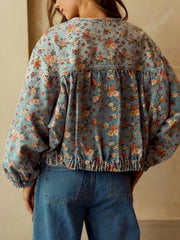 Cropped denim trucker jacket with floral print, elasticated hem and cuffs, and gathered back detail.