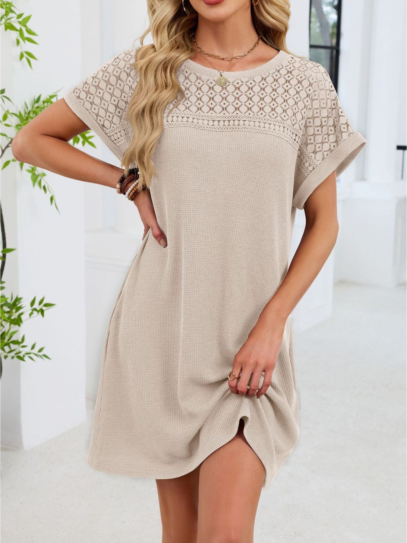 Beige t-shirt dress with sheer lace yoke and short sleeves.