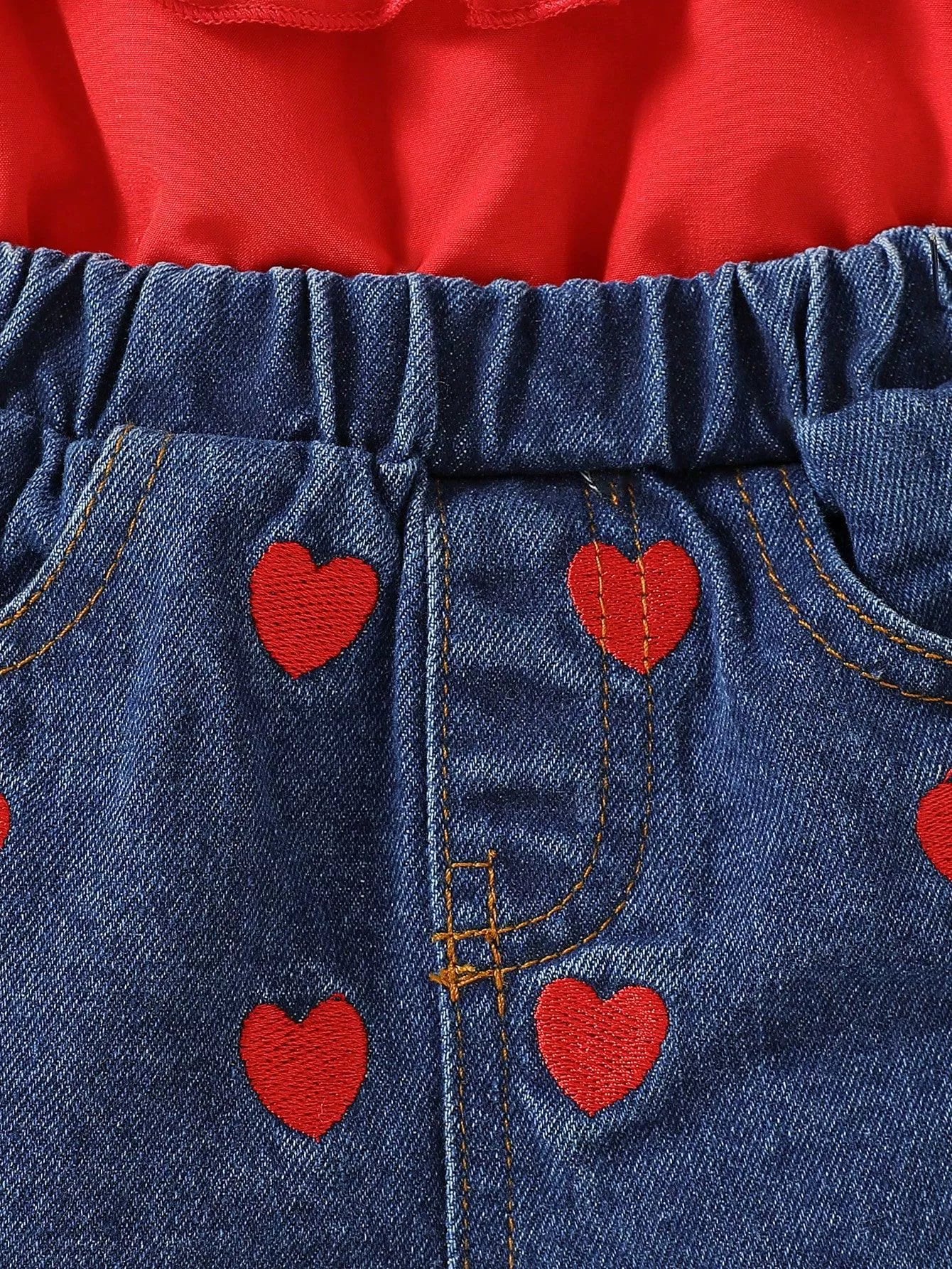 Red ruffled top with denim shorts featuring red heart embroidery
