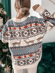 Fair Isle reindeer motif knit sweater with snowflake and diamond patterns in cream, blue, and brown.