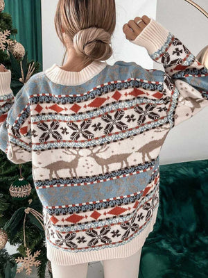 Fair Isle reindeer motif knit sweater with snowflake and diamond patterns in cream, blue, and brown.