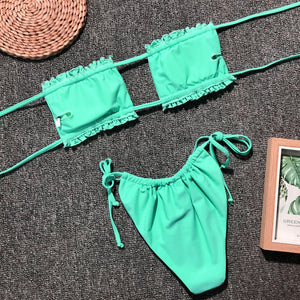 Neon green ruffled bandeau bikini set with tie-side bottoms.