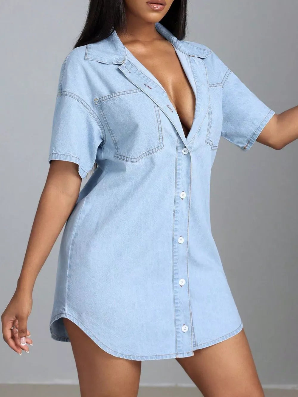 Light wash denim shirt dress with short sleeves, collared neckline, button front, and chest pockets.