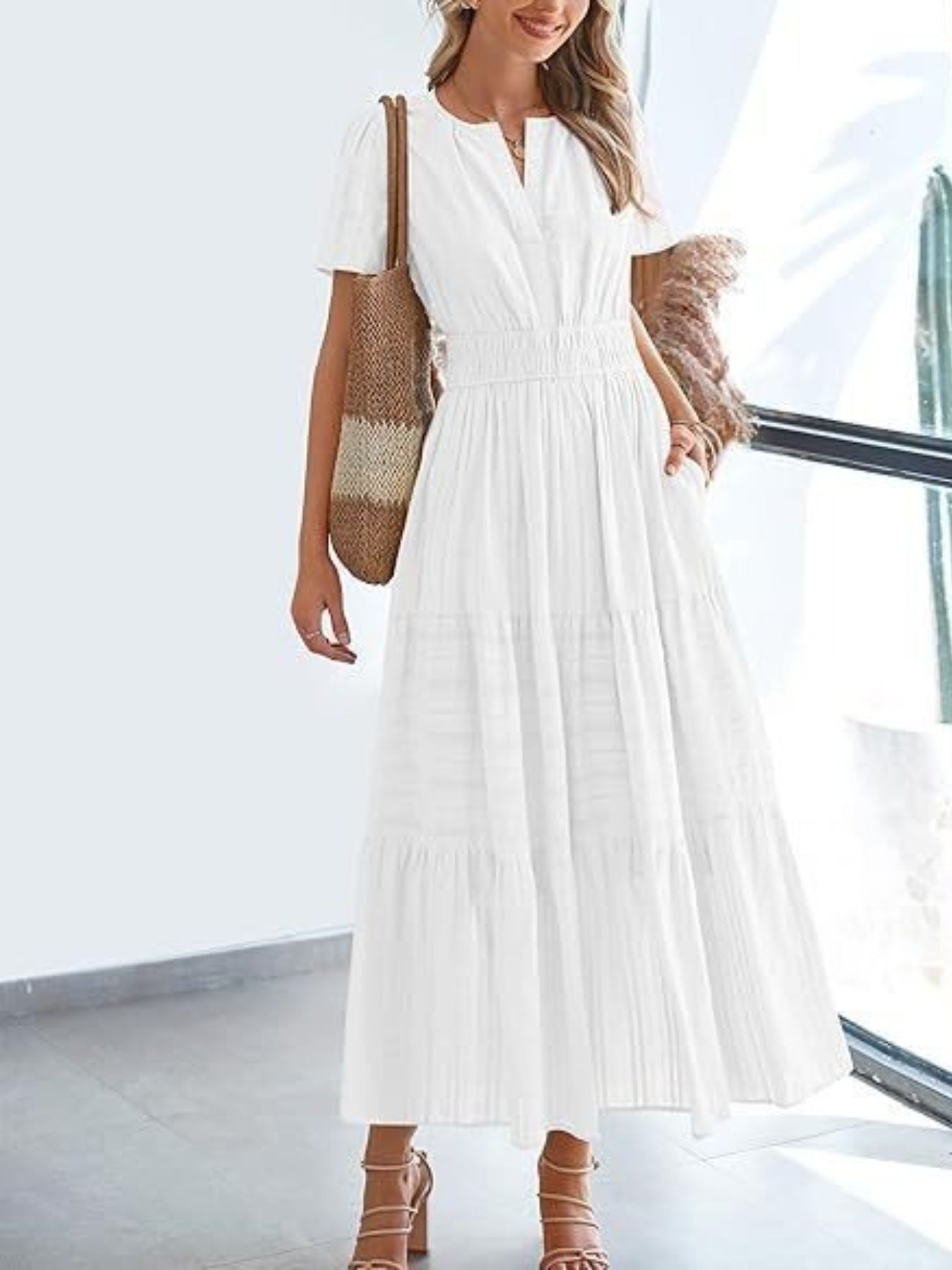 White V-neck tiered maxi dress with smocked waist and short sleeves.
