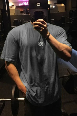 Logo Detail Oversized Tee in Dark Gray with a small white logo detail on the chest.