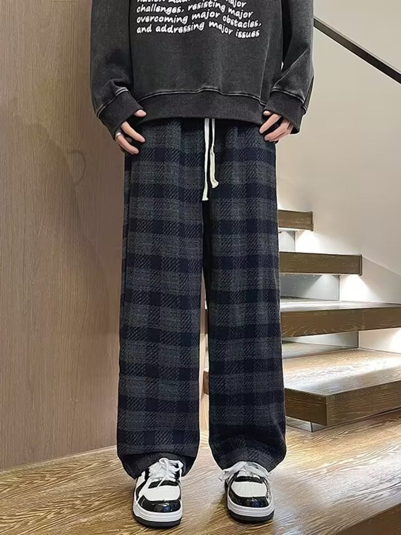 Men's dark gray plaid wide leg trousers with drawstring waist.