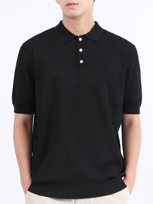 Black textured knit polo shirt with classic collar and short sleeves.