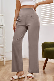 High-waisted flare leg trousers in tan with pockets, styled casually.