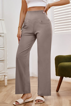 High-waisted flare leg trousers in tan with pockets, styled casually.