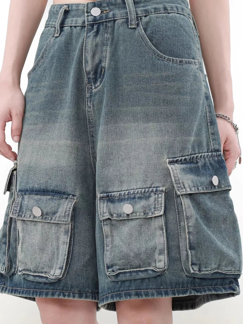 Men's blue denim cargo shorts with multiple pockets and a faded wash.