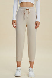 Beige joggers with drawstring waist and cuffed ankles