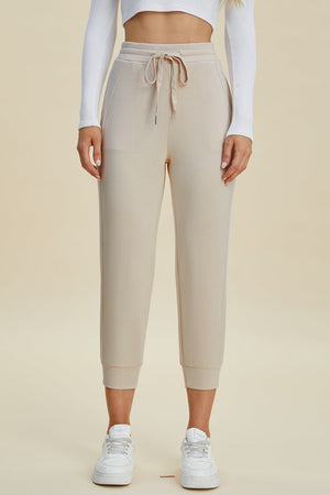 Beige joggers with drawstring waist and cuffed ankles