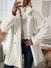 White faux shearling double-breasted coat with cable knit texture and button closure.