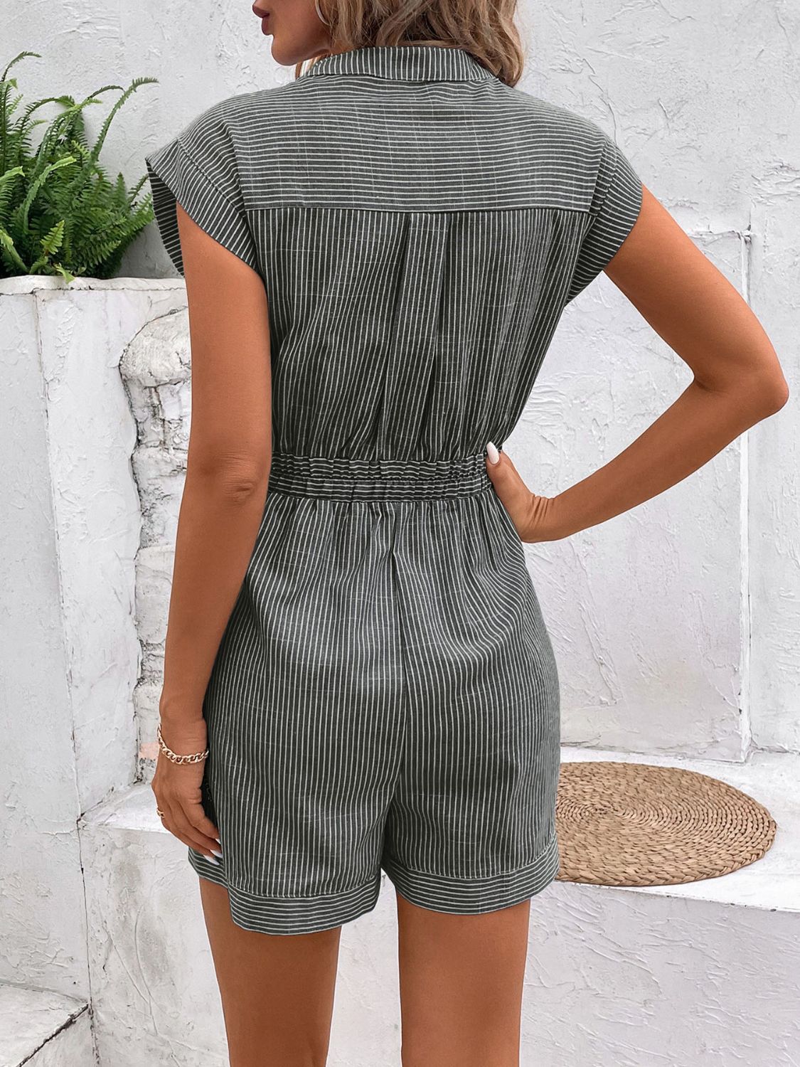 Striped shiriting romper in Gum Leaf with cinched waist and short sleeves.
