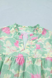 Pastel floral print polyester blouse with ruffled neckline and V-neck detail