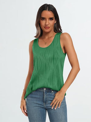 Textured wave tank top in dark green with a scoop neck, styled with jeans.