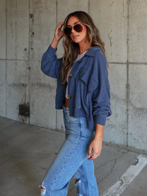 Peacock blue textured utility shirt jacket with button front and chest pockets.