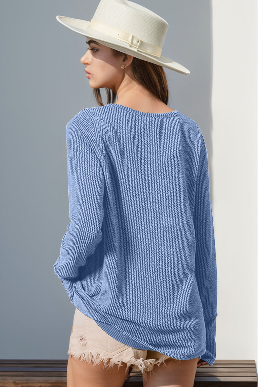 Light blue waffle knit henley shirt with thumbhole cuffs, long sleeves and a relaxed fit.
