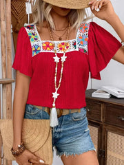 Red embroidered square neck flutter sleeve blouse with colorful floral detail.