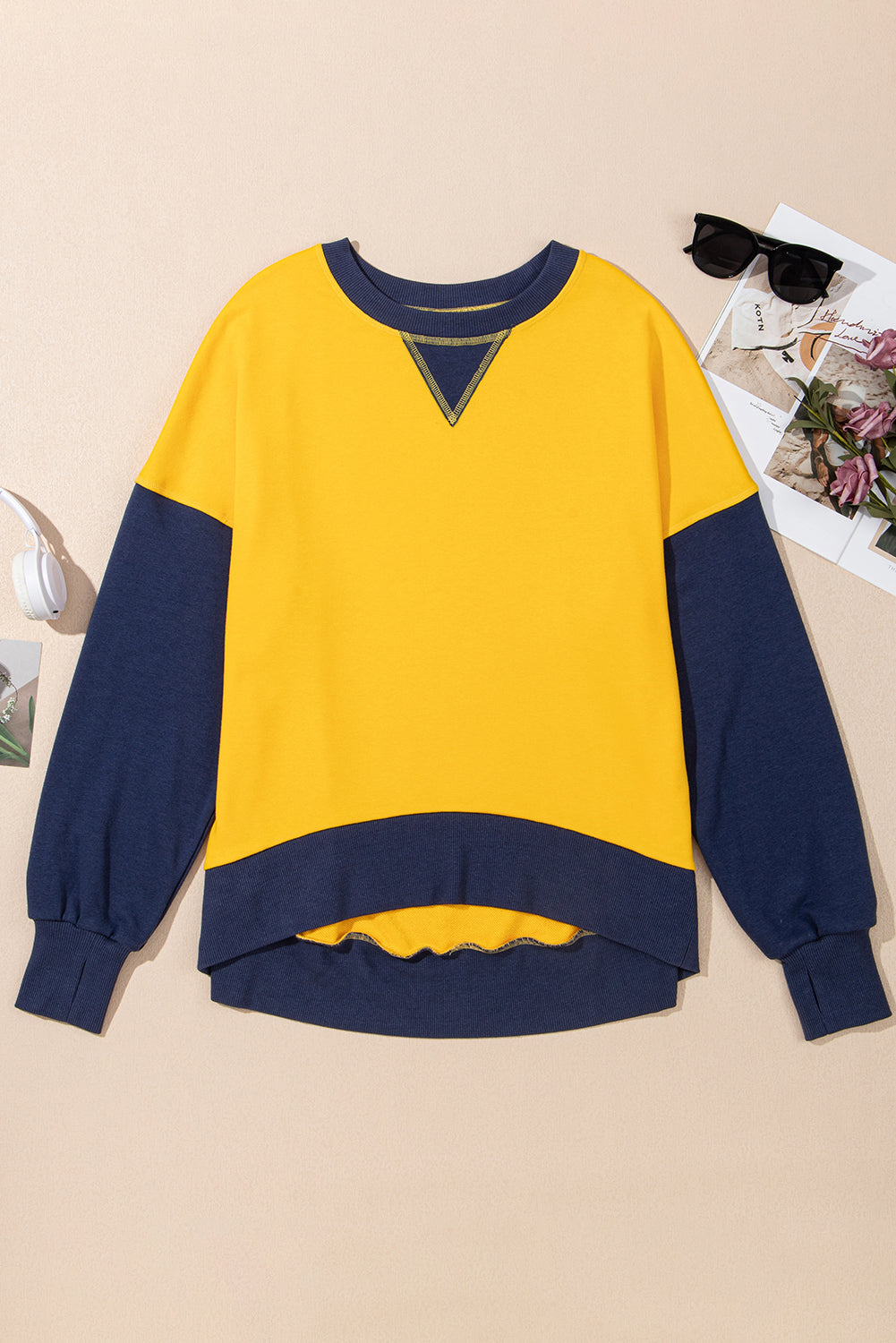 Yellow and navy contrast crewneck sweatshirt with a V-stitch detail at the neckline.