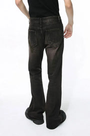 Dark wash bootcut denim jeans with a faded effect and flare leg, shown from the back.