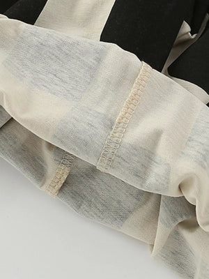 Toddler cotton color-block set with black and cream stripes and visible stitching detail.