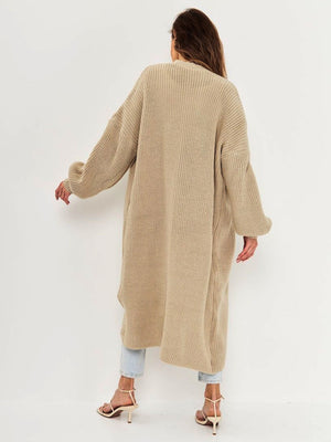 Oversized tan ribbed knit maxi cardigan with balloon sleeves, shown from the back.
