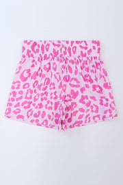 Pink leopard print shorts with elastic waistband and scalloped hem.