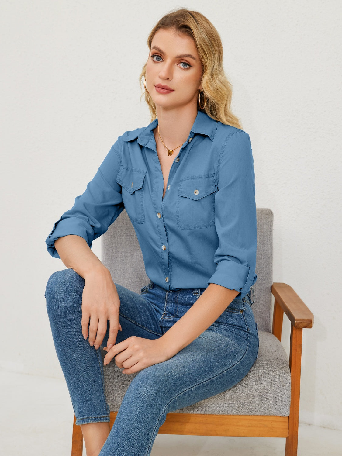 Light wash denim utility shirt with two chest pockets and button front.