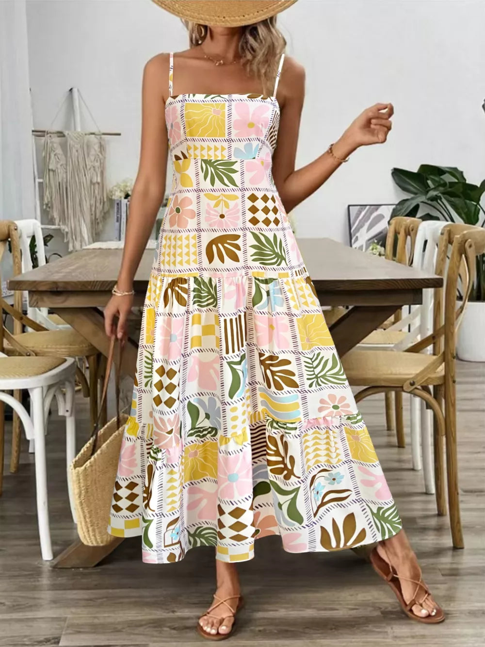 Vibrant cutout back cami dress with a colorful floral and leaf print, tiered skirt, and square neckline.