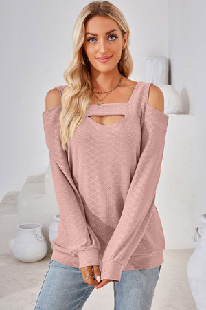 Blush pink geometric cutout shoulder top with square neckline and long sleeves.